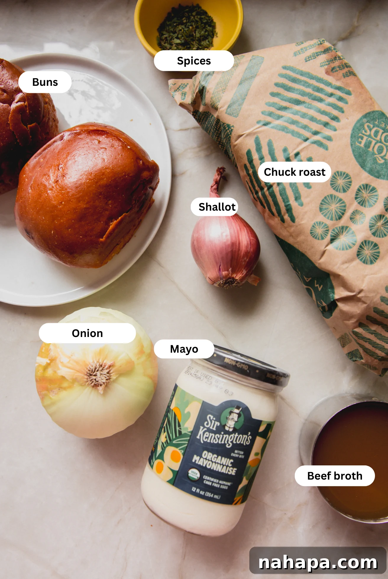 A vibrant flat lay of all the fresh and essential ingredients required to prepare the flavorful pot roast sandwiches.