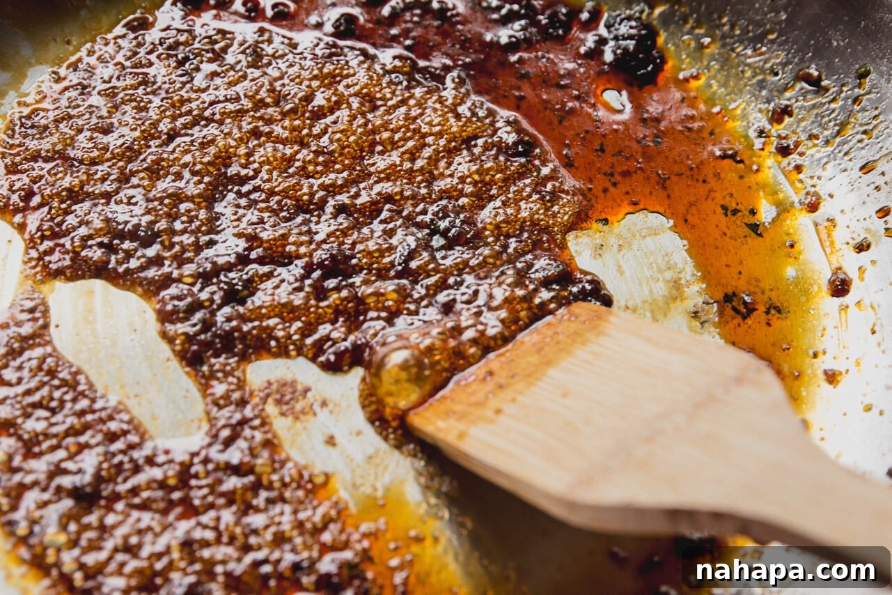 The pan being deglazed with coconut aminos, scraping up all the delicious browned bits from the bottom.