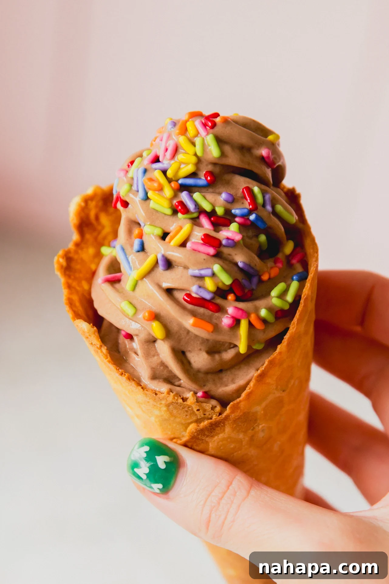 Dairy Free Ninja creami protein ice cream in a cone topped with sprinkles.