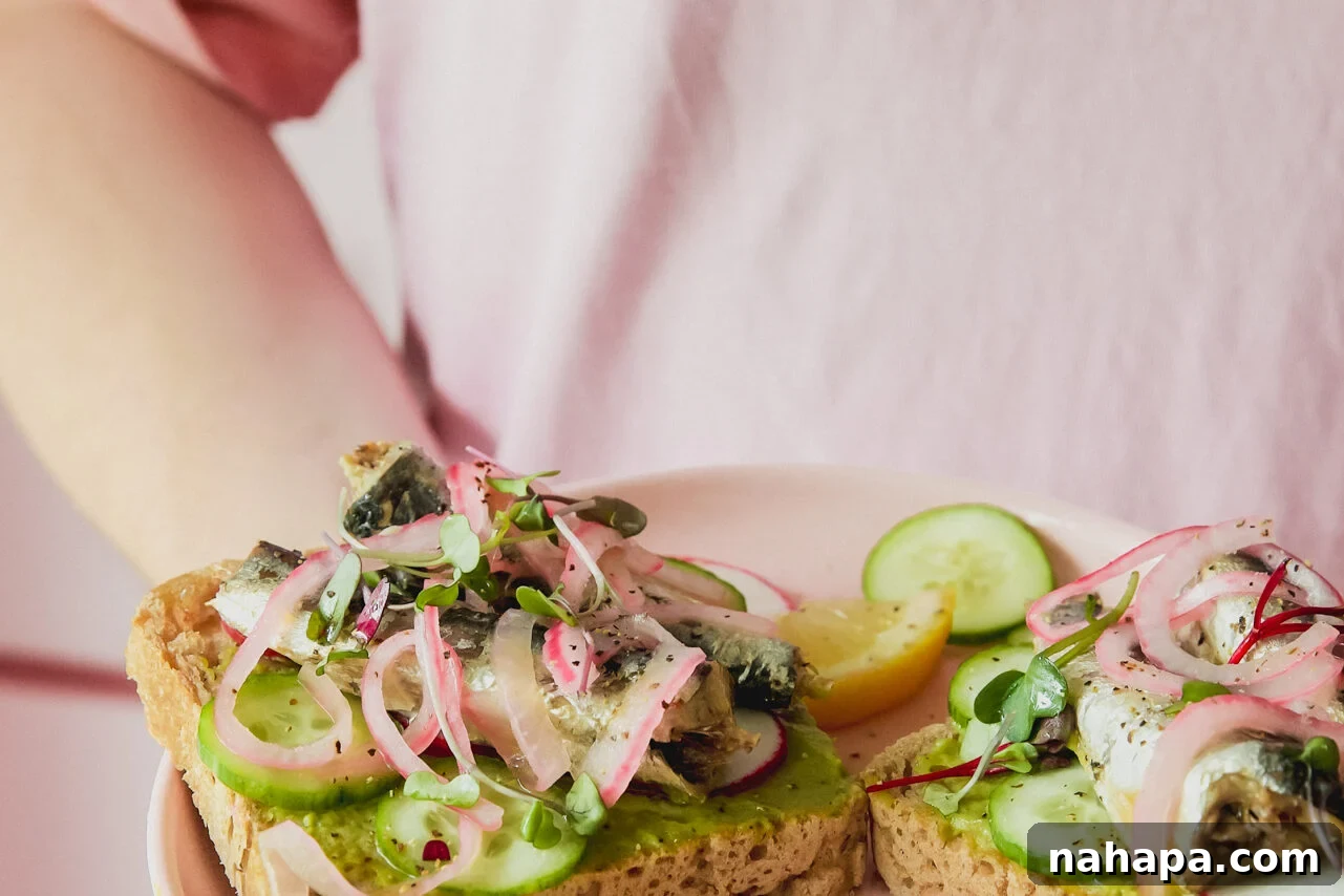A plate with two pieces of sardine toast on it.