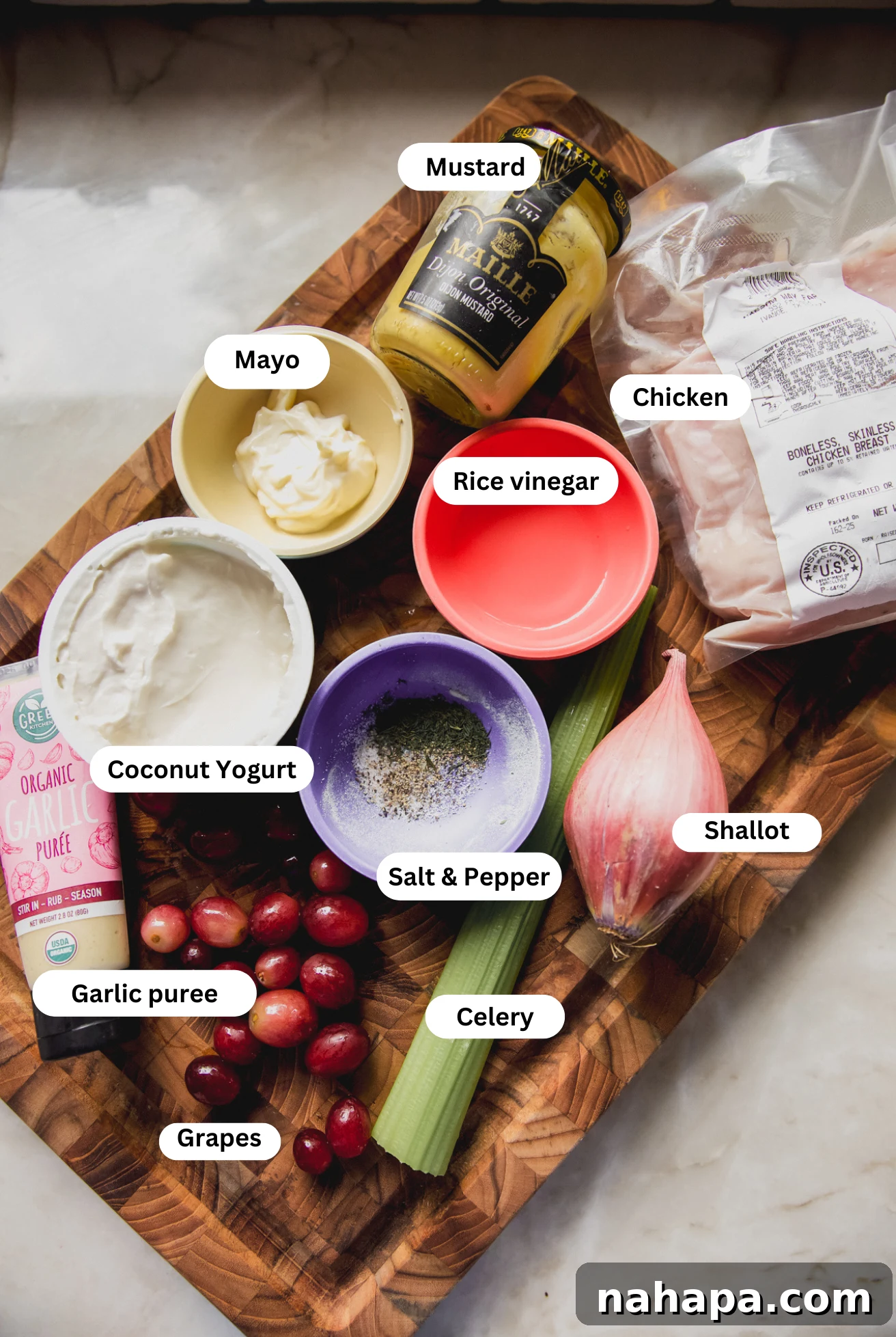 A flat lay image displaying all the fresh and vibrant ingredients needed to prepare the chicken salad with grapes.