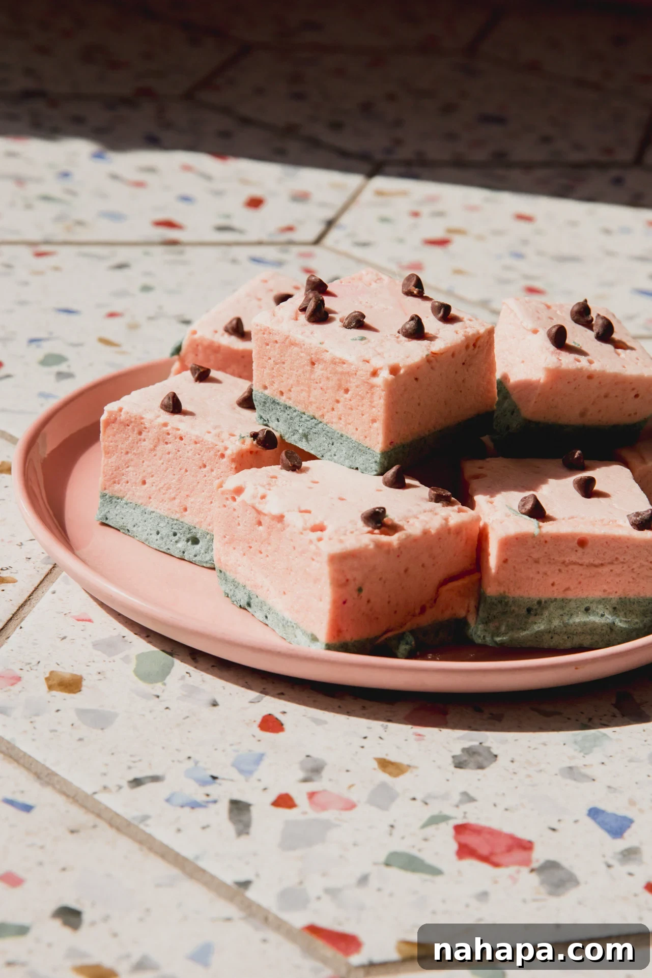 Watermelon Cloud Treats 11 Watermelon marshmallows stacked on a pink plate.