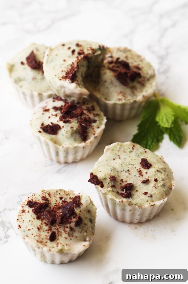 Healthy Mint Chip Banana Nice Cream Cups (Paleo AIP Vegan) 2 A stack of refreshing mint chocolate chip ice cream cups on a kitchen counter, ready to be enjoyed.