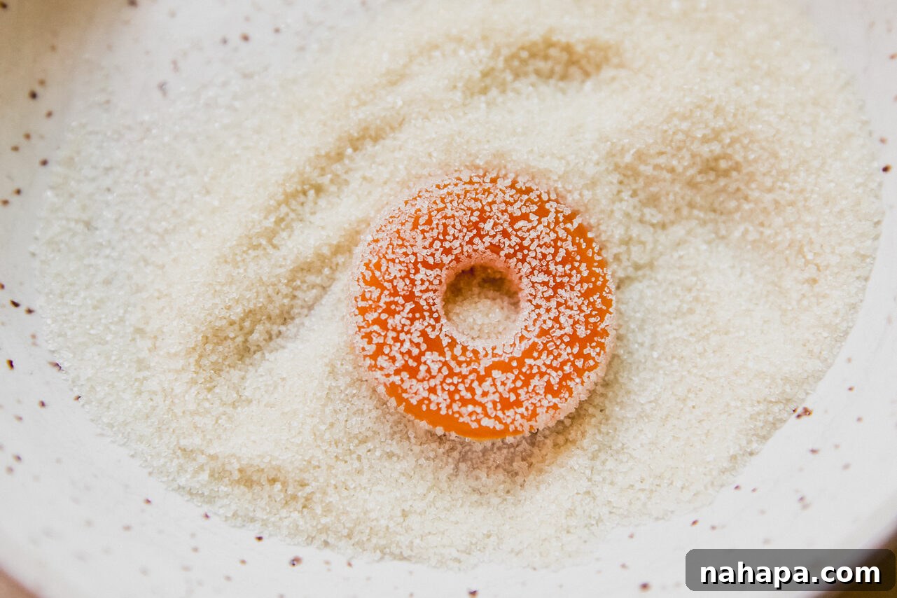 Peachy Protein Rings 9 Protein peach rings generously tossed in granulated sweetener, gleaming and ready to be enjoyed.