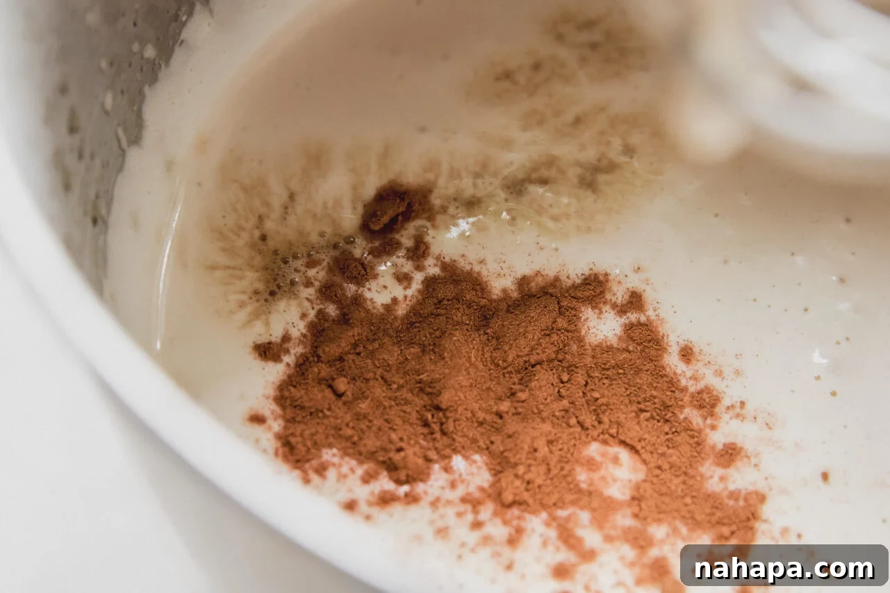 Pumpkin Spice Marshmallow Cloud 5 Pumpkin spice marshmallow fluff in a stand mixer with the pumpkin spice not mixed in.
