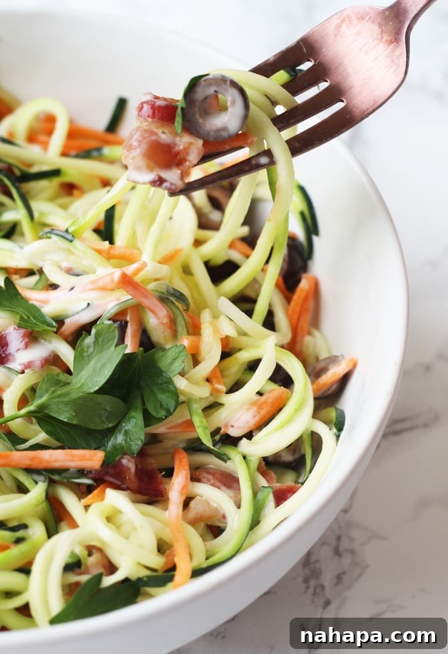 Bacon Ranch Zucchini Noodle Pasta Salad (Paleo, AIP, Whole 30) served in a large white bowl, garnished with fresh parsley