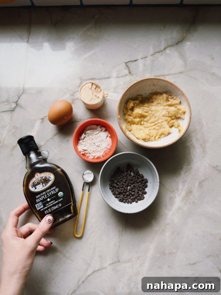 Assortment of banana breakfast cake ingredients including bananas, eggs, flour, and chocolate chips.