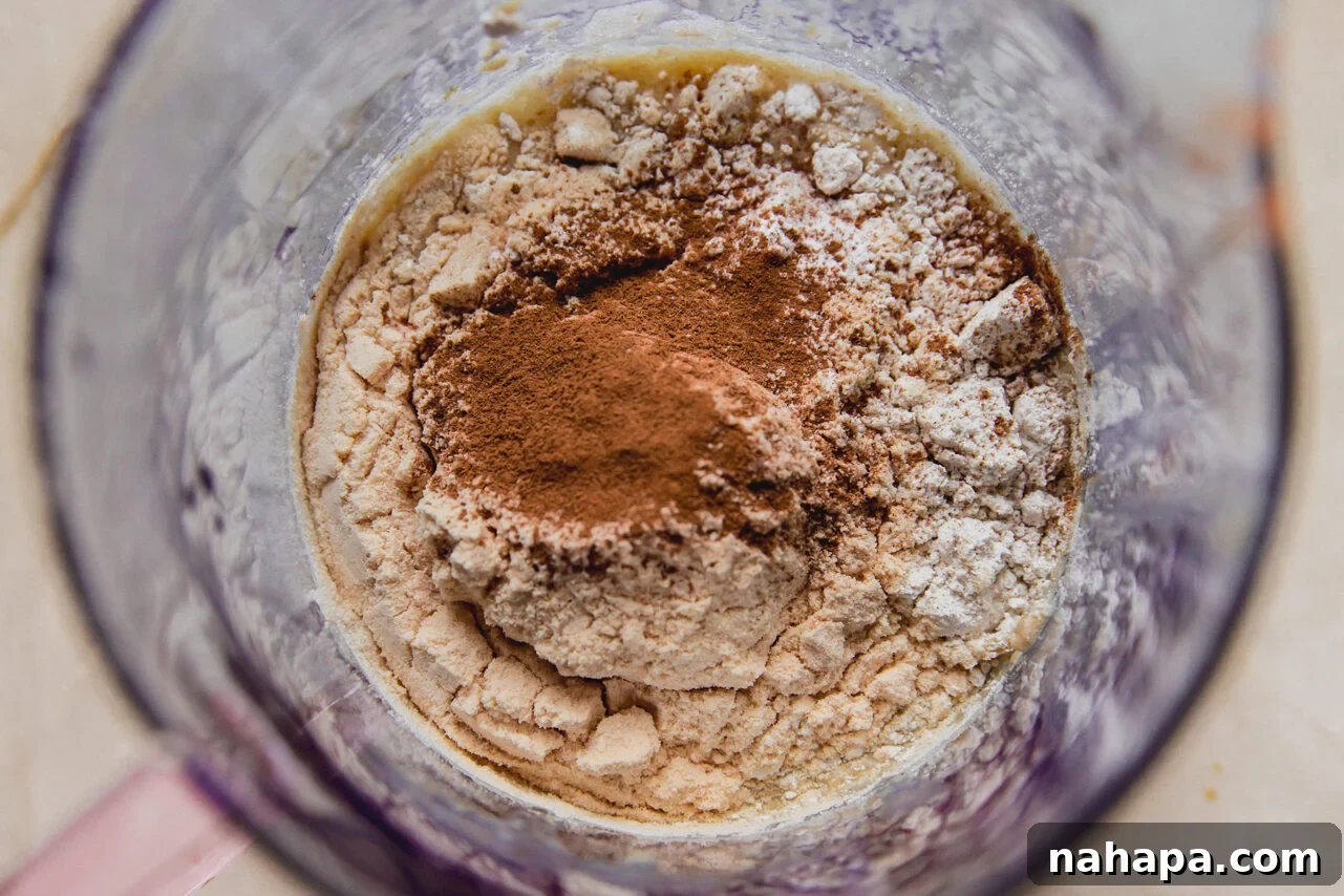 Dry ingredients added to the wet ingredients in a measuring cup before final blending.