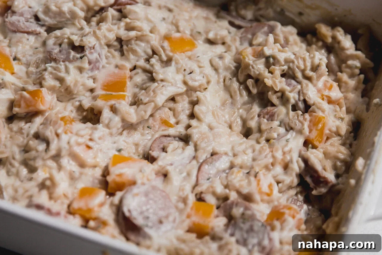 The finished one pan chicken sausage and orzo bake, creamy and ready to be served.