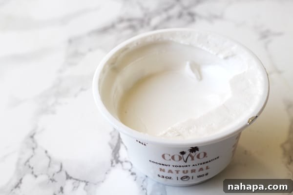 Mastering Your Microbiome The Essential Toolkit 3 A countainer of Coyo Coconut yogurt with the top off sitting on a counter.