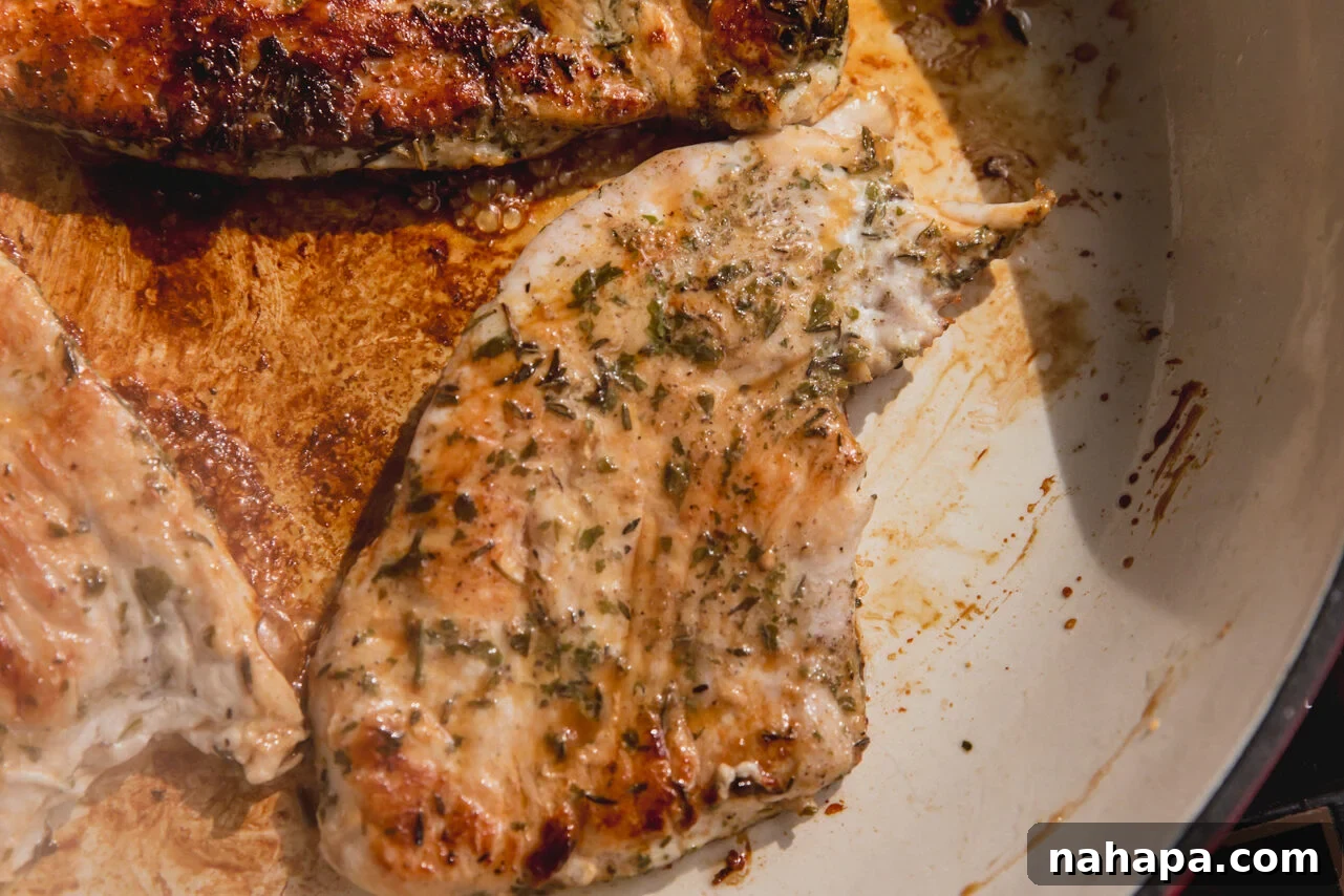 Golden-brown turkey cutlet searing in a hot pan, demonstrating proper cooking technique for tender results.