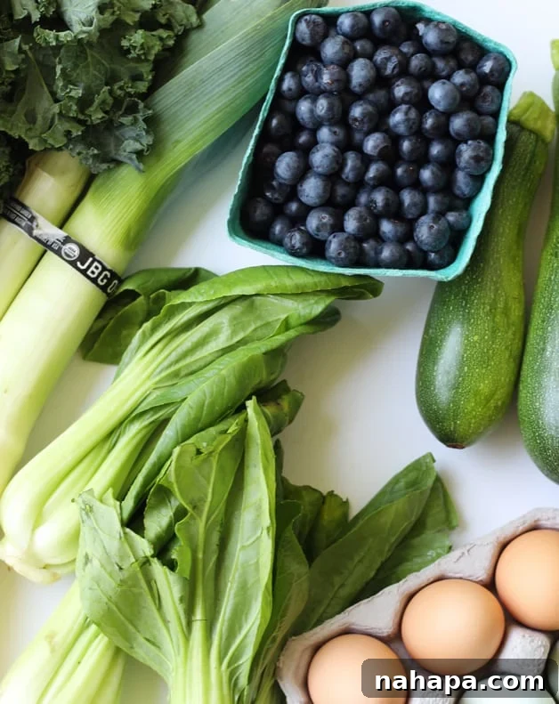 A collection of seasonal produce laid out on a counter before cooking.