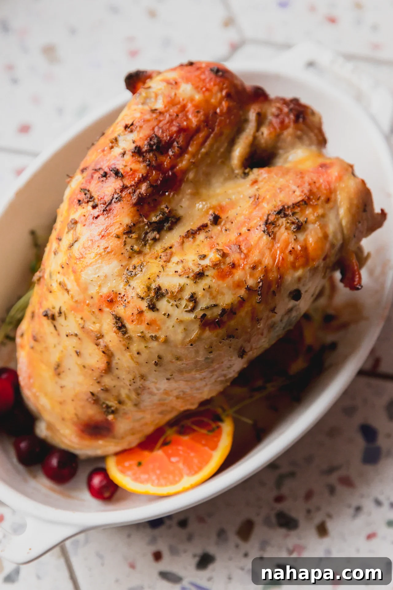 Tender Maple Dijon Slow Cooker Turkey Breast 8 Fully cooked slow cooker turkey breast in a white serving dish.