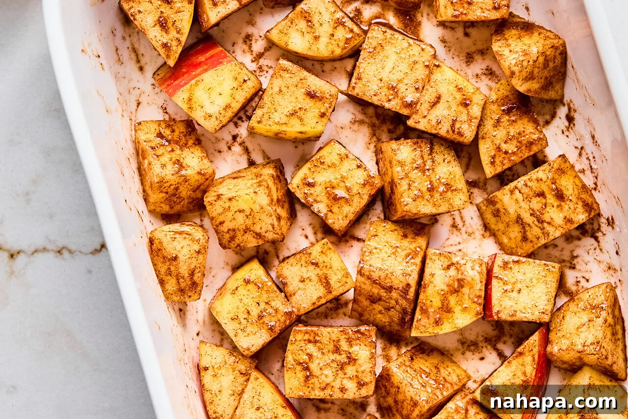 Protein-Packed Apple Crisp 6 Diced Honeycrisp apples in a baking dish before any other ingredients are added.