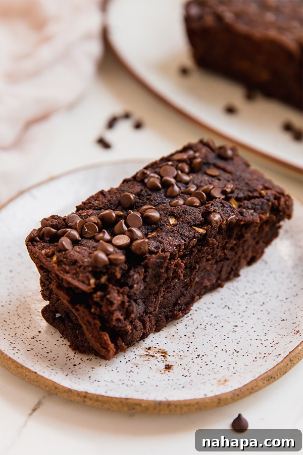 A beautiful, moist slice of chocolate zucchini bread showing its tender crumb.