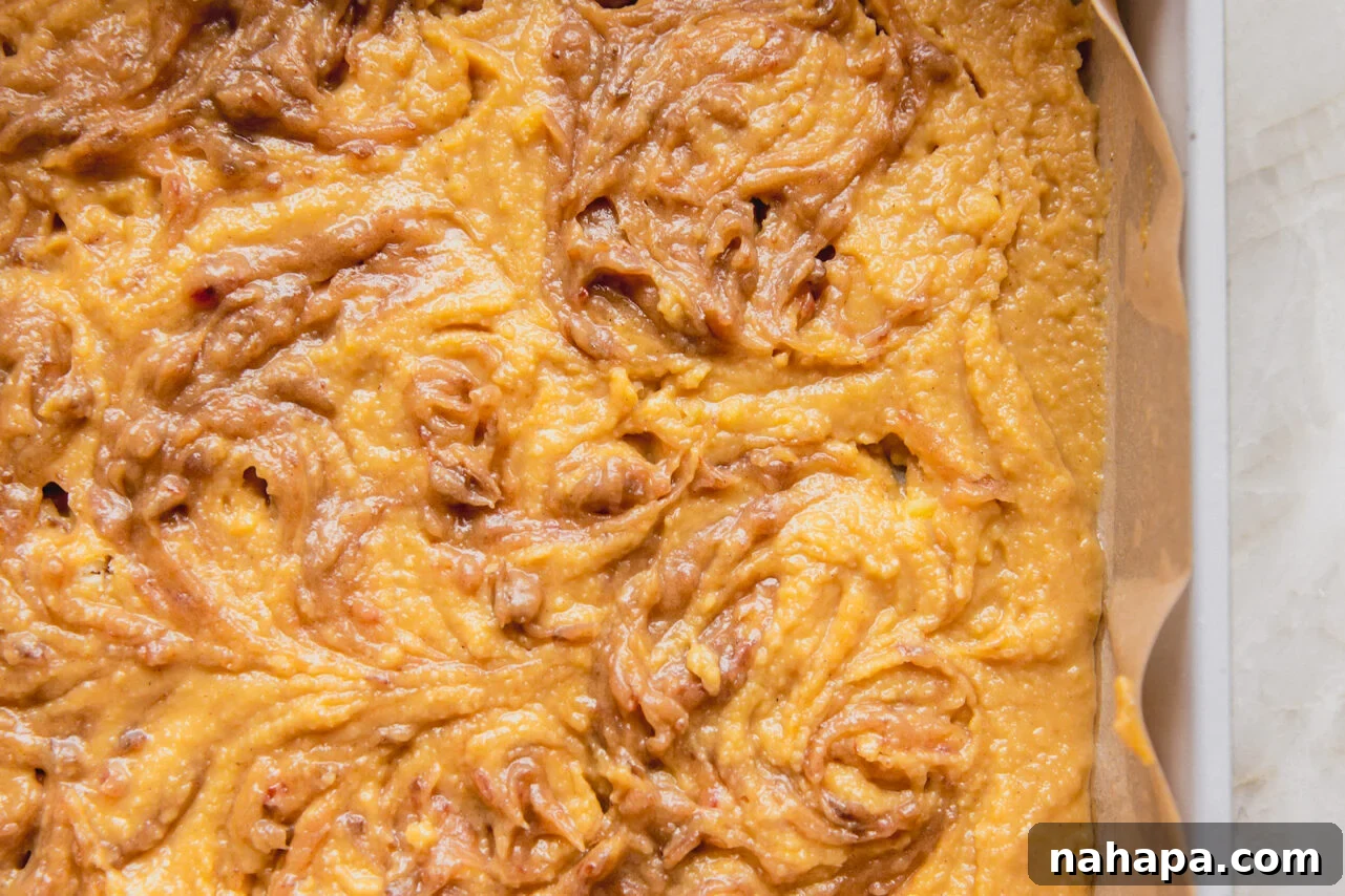 The cinnamon roll cake batter all in the pan and ready to go in the oven.