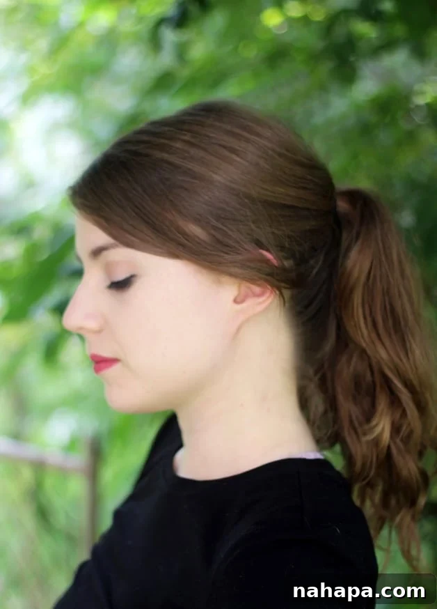 A close up of Michelle from the side while she is looking down.