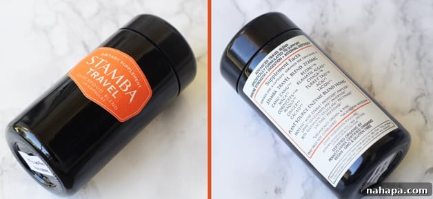 YBC Mantra Box Summer 2017 Unveiled Natural Paleo and Yoga Essentials 4 A sleek bottle of Stamba Super Food Blend, specifically designed for travel, displayed with clear images of its front and back labels to highlight ingredients and usage, set against a neutral background.