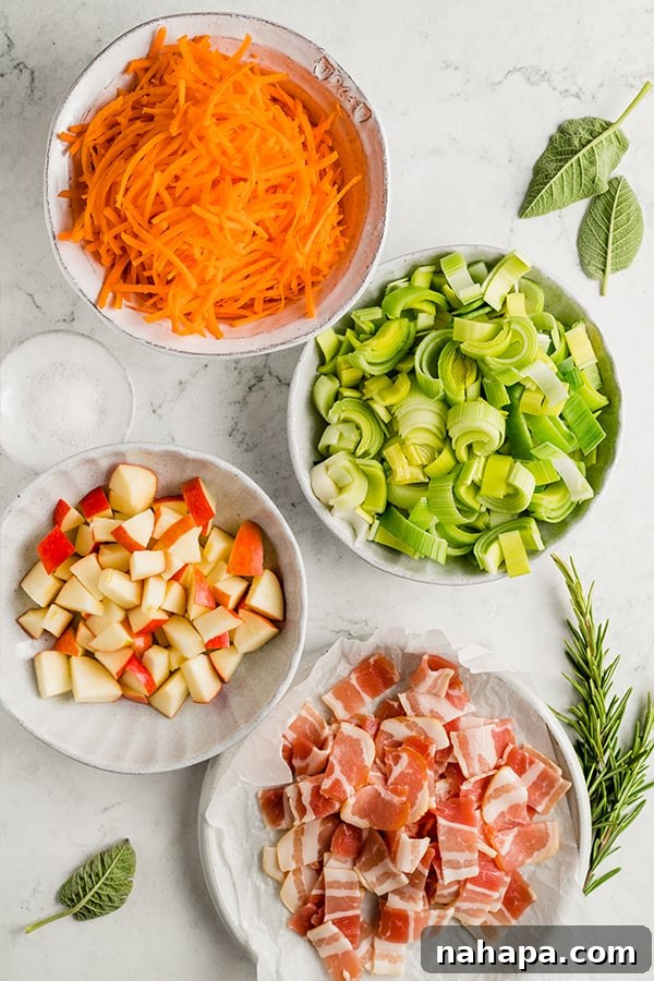 Sweet and Savory Whole30 Paleo AIP Carrot Apple Bacon Hash 3 Shredded carrot, chopped leeks, chopped apples, and chopped bacon in bowls, ready for cooking