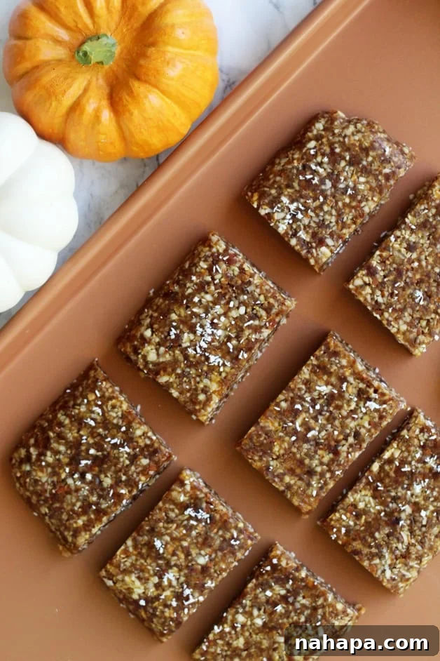 A close-up of a batch of fresh pumpkin energy bars, showcasing their texture and autumnal ingredients.