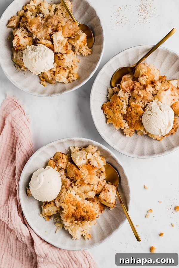 Three individual servings of Paleo, AIP, and Vegan apple crisp on plates with spoons, ready to be enjoyed.