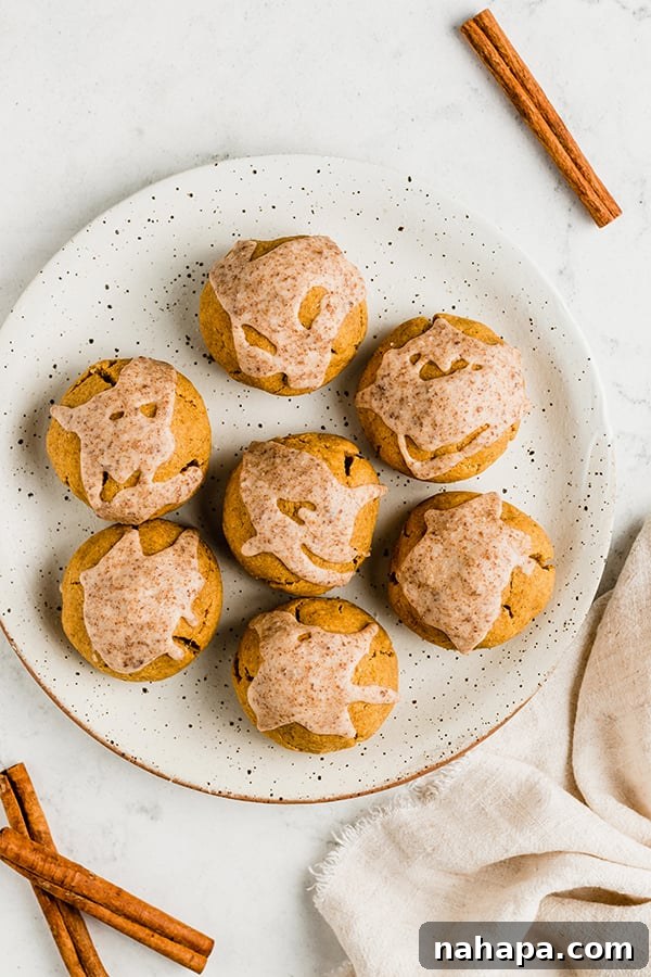 A beautifully arranged plate of pumpkin pie donut holes, glazed and ready to be served.
