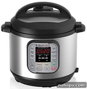 Paleo Holiday Gift Guide 3 A sleek, silver Instant Pot sits prominently on a kitchen counter, ready for use. Its digital display and various function buttons are clearly visible, highlighting its modern design and ease of operation.