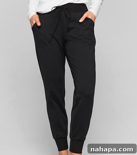 Paleo Holiday Gift Guide 6 A person models a stylish pair of black joggers, demonstrating their comfortable fit and versatile appeal. The fabric drapes softly, emphasizing both comfort and a modern silhouette.