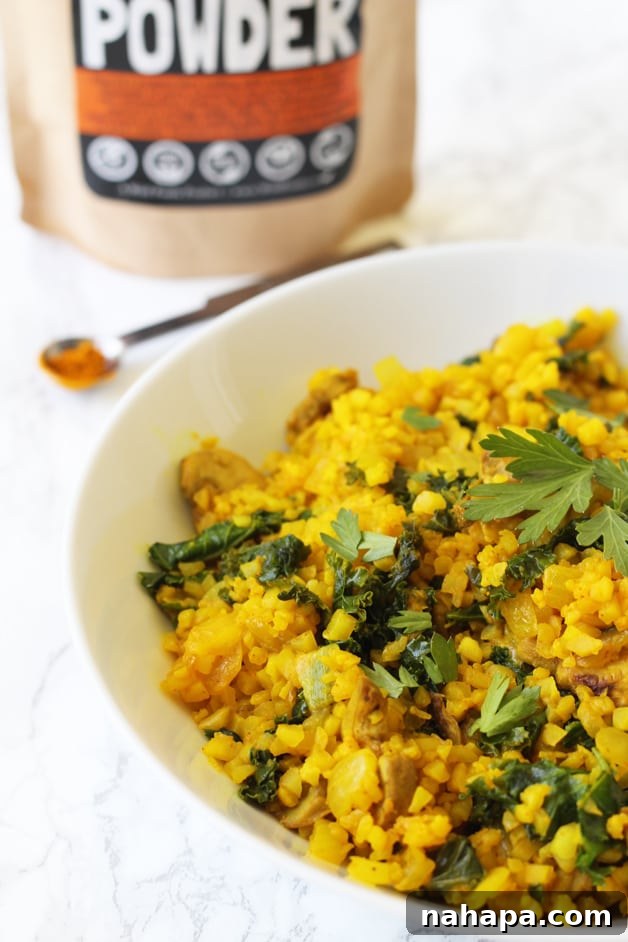 A bowl of turmeric cauliflower risotto topped with fresh herbs, symbolizing healthy and delicious meal options.