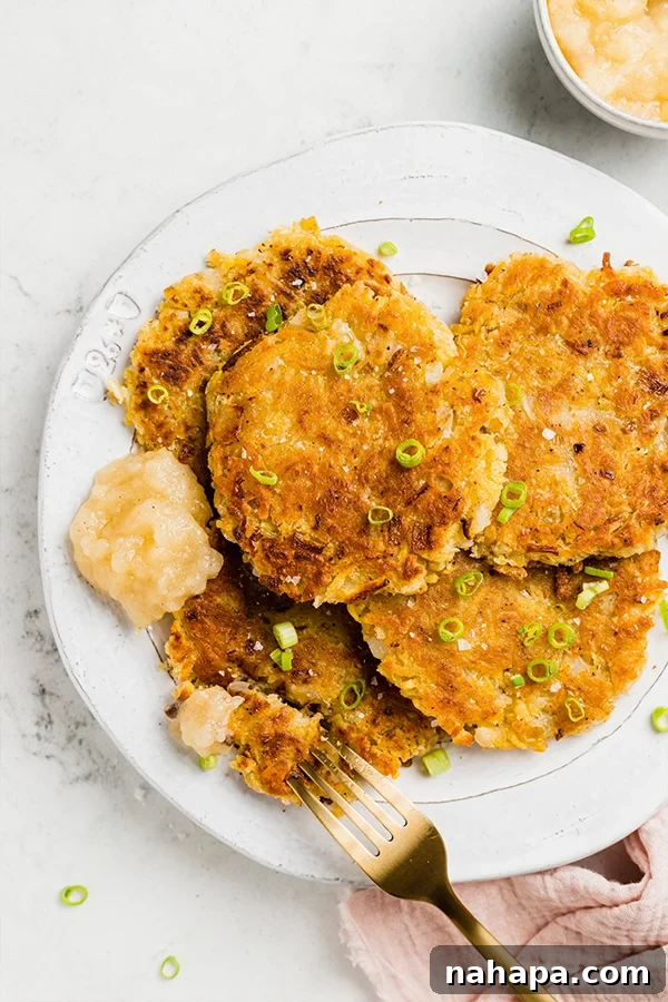 Close-up of crispy Sweet Potato Latkes with green onion garnish