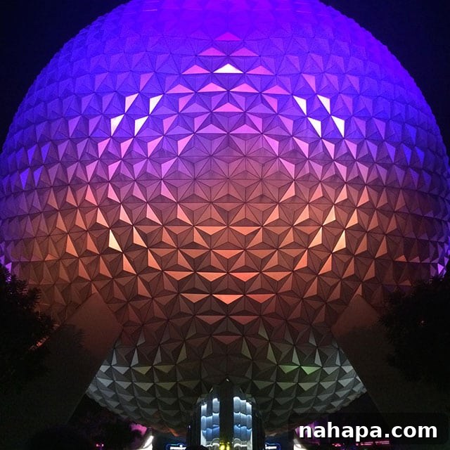 Thriving at Disney World: AIP Paleo Food Allergy Adventures 8 Happy visitor posing in front of Epcot's World Showcase lagoon with Spaceship Earth in the background, signaling a successful allergy-friendly day.