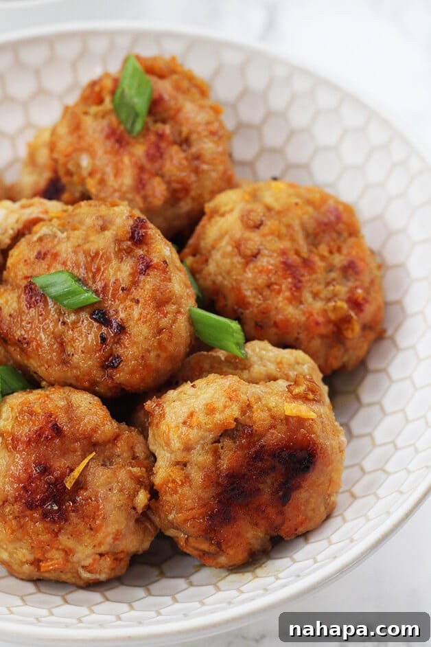 Platter of freshly made Orange Chicken Poppers garnished with green onions