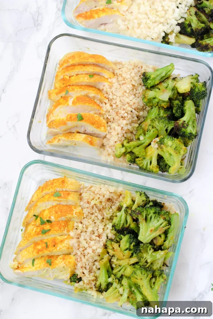Wellness Turmeric Chicken Meal Prep 3 Two glass meal prep containers filled with turmeric chicken, cauliflower rice, and roasted broccoli.