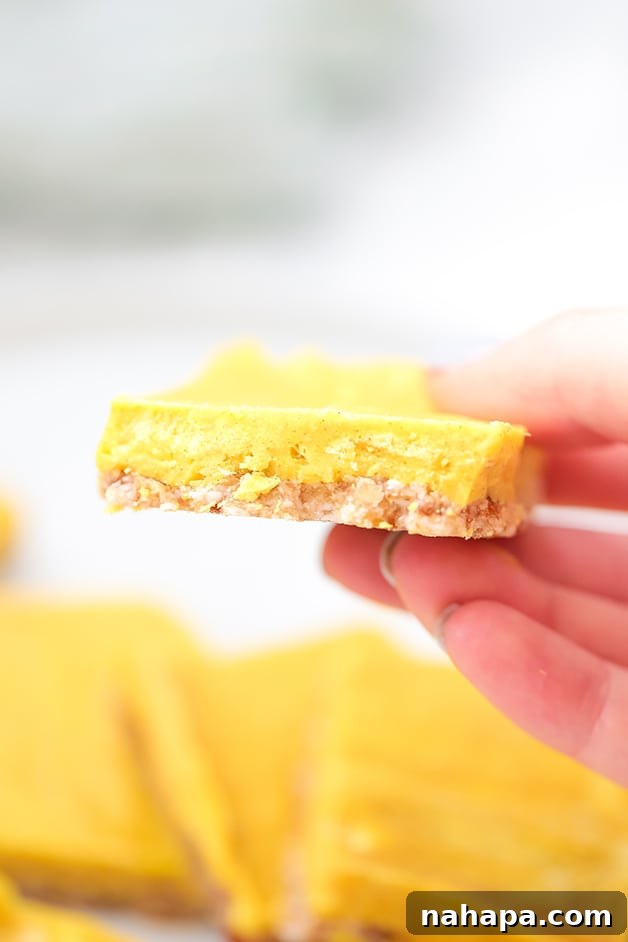 A hand holding a golden anti-inflammatory turmeric bar, ready to be enjoyed as a healthy snack.