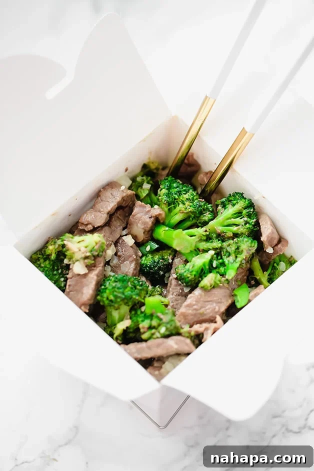 Wholesome Beef and Broccoli Whole30 Paleo AIP 3 A white takeout container filled with beef and broccoli and chopsticks in it.