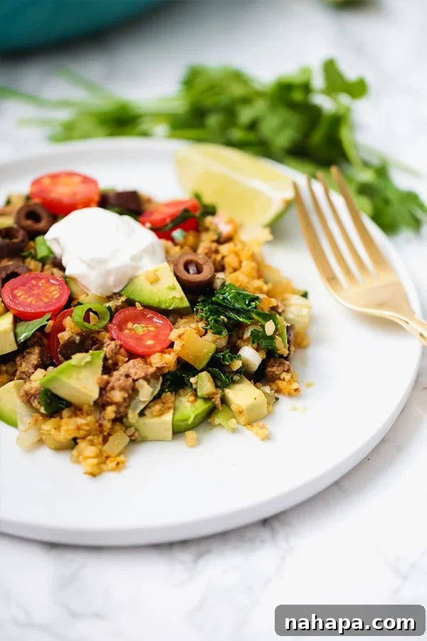 A vibrant one-pan taco skillet filled with ground beef, vegetables, and seasoning.