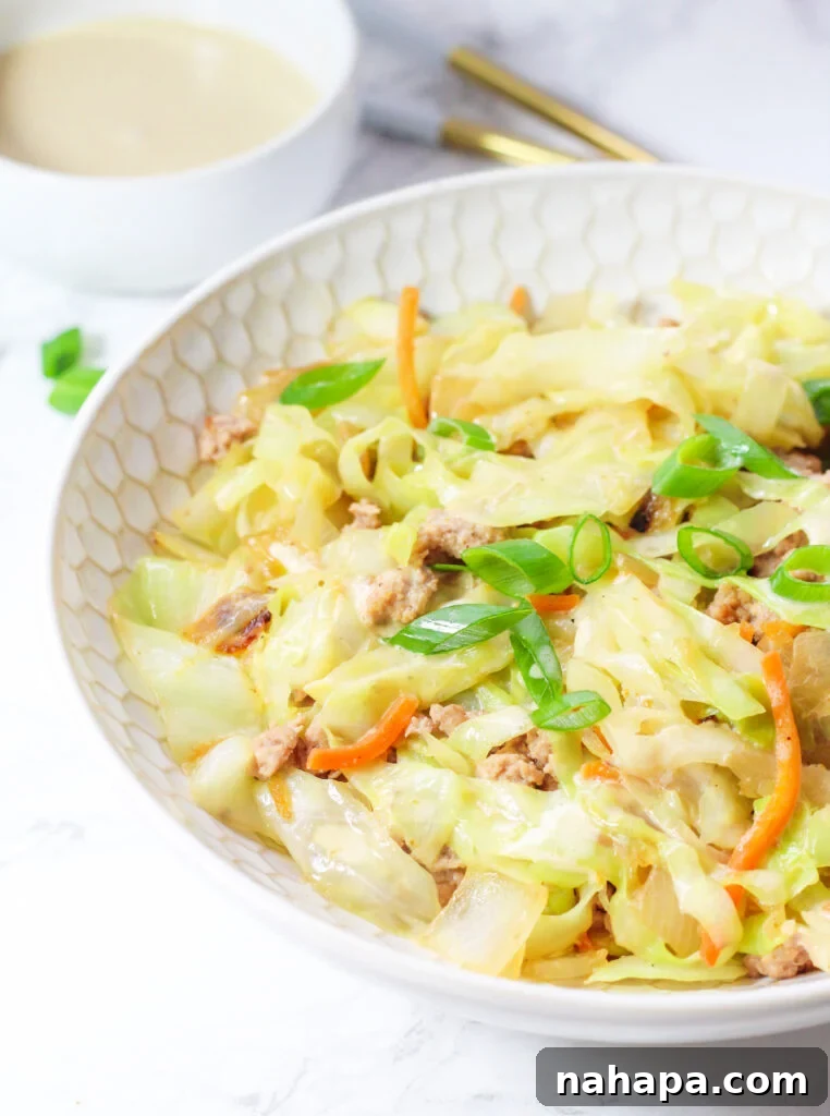 A white bowl filled with a savory egg roll in a bowl mixture.