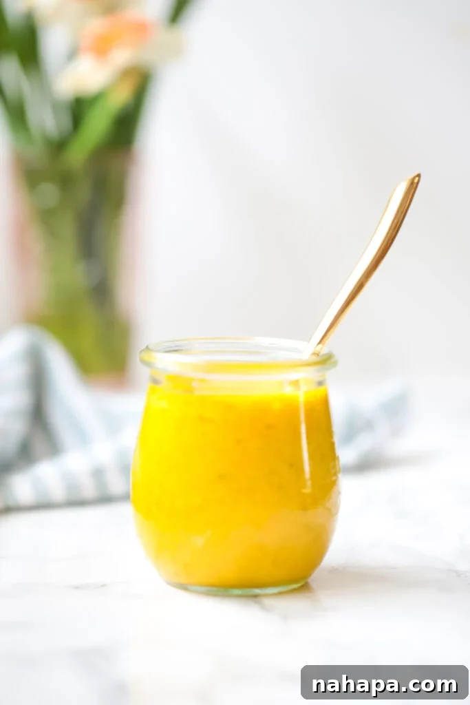 Clean Eating Turmeric Dressing 3 A bowl of fresh vegetables topped with Anti-inflammatory Turmeric Dressing.
