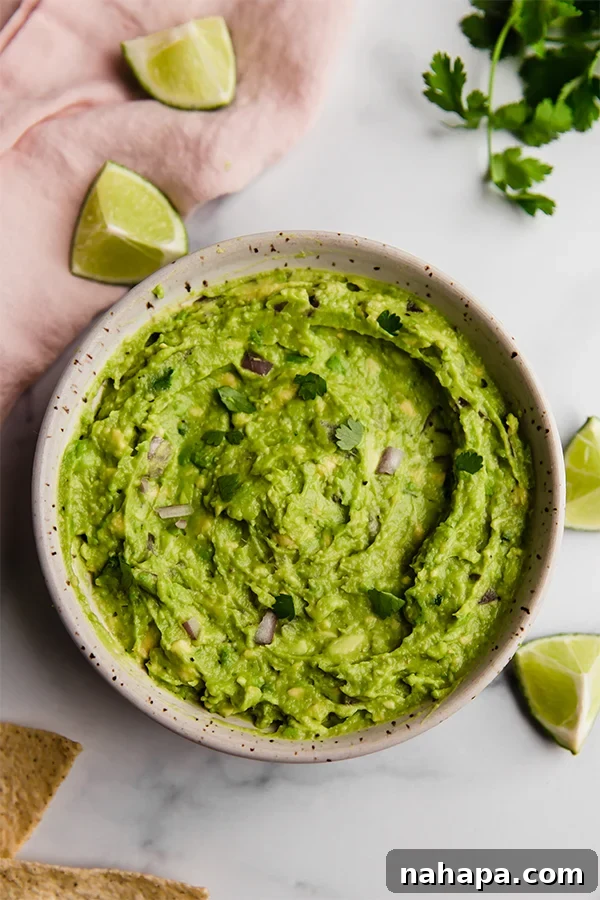 Effortless AIP Guacamole Paleo Whole30 2 Top view of prepared guacamole in bowl on counter