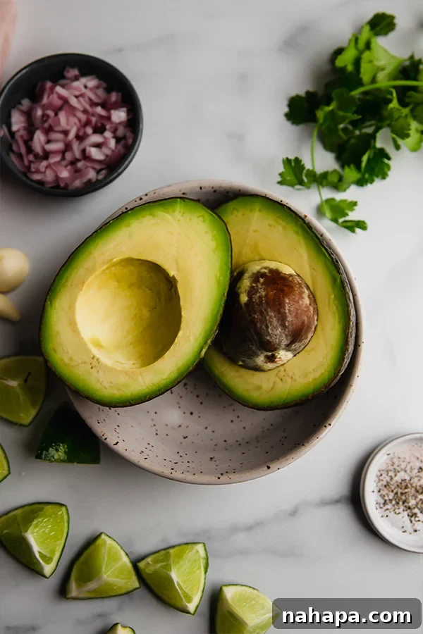 Effortless AIP Guacamole Paleo Whole30 3 Avocado cut in half in bowl