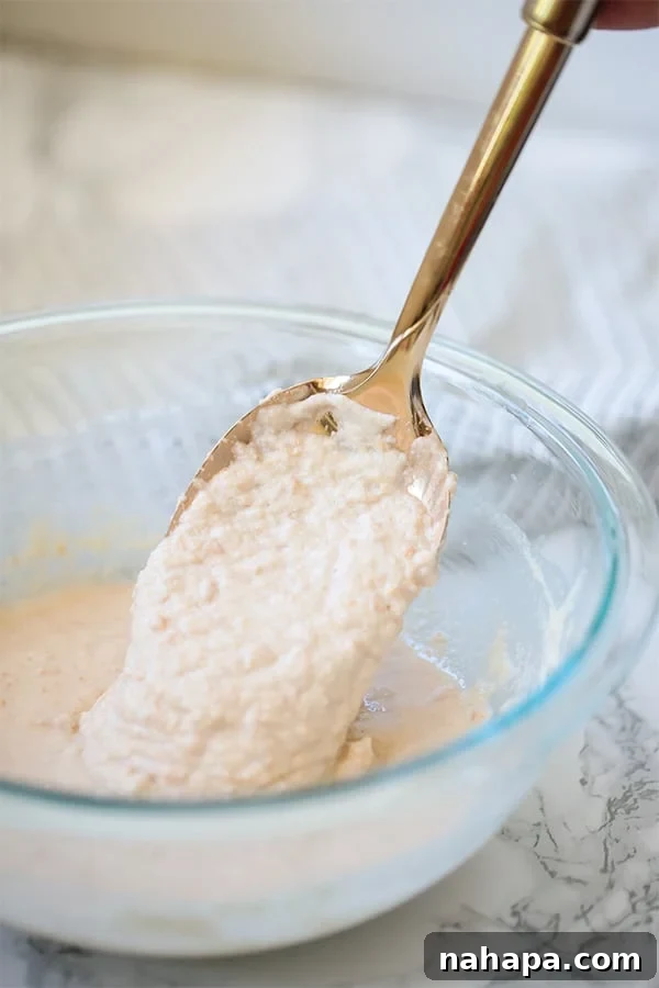 Delicious Paleo Vegan Gluten Free Pancake Skewers 4 A bowl of pancake batter with a spoon mixing it.