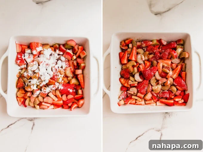 Paleo AIP Vegan Strawberry Rhubarb Crumble 4 A baking dish filled with a vibrant mix of sliced strawberries and chopped rhubarb, coated with arrowroot starch and coconut sugar, ready for the topping.