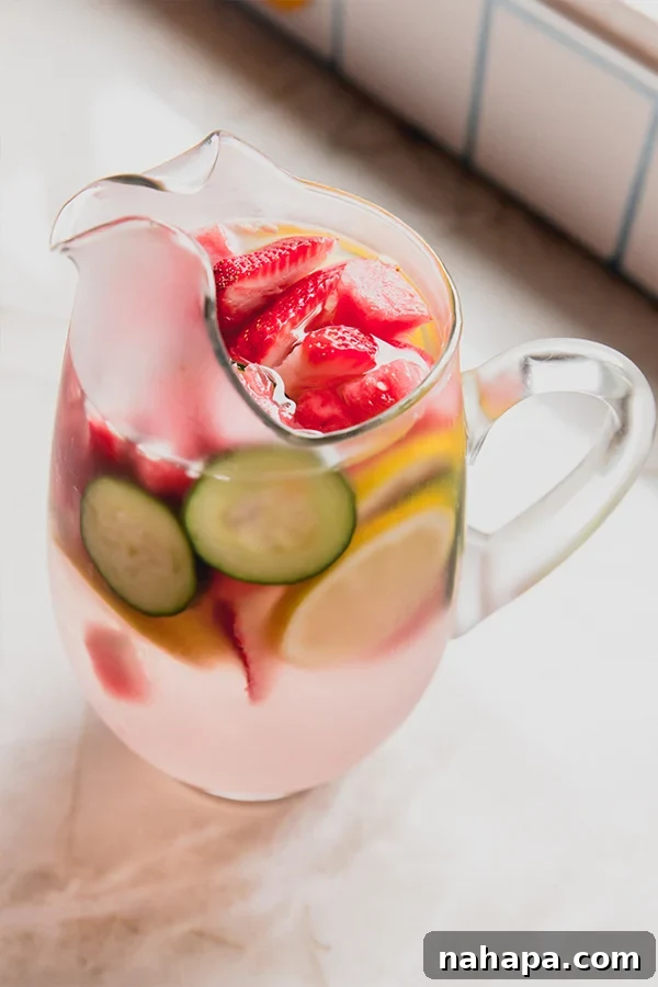 Ginger Wellness Elixir 4 A glass of ginger infused water with fruit slices and ice