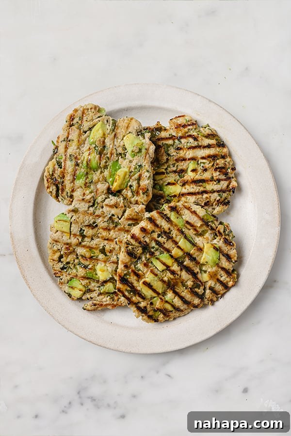 Cooked Spinach Avocado Chicken Burger patties on a grill pan