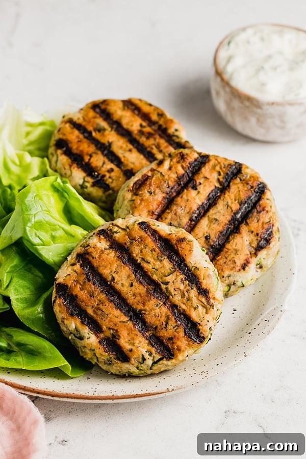 Grilled Greek chicken burgers beautifully arranged on a plate, ready to be served