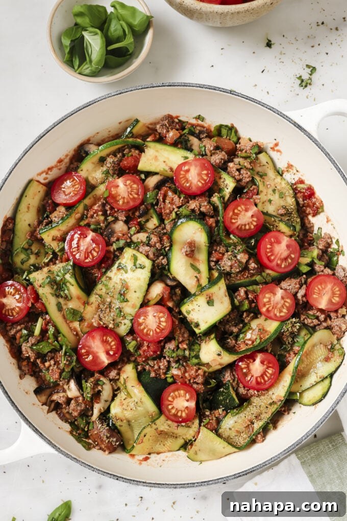 A rich and savory one-pot zucchini lasagna skillet, topped with fresh herbs and ready to be served, perfect for a healthy family dinner.