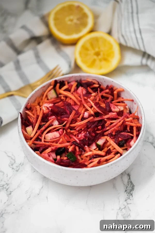 Detox Carrot Slaw: Recipe and The Truth About Detox 2 A beautifully presented bowl of detox carrot slaw with a fork resting beside it, garnished with fresh herbs.