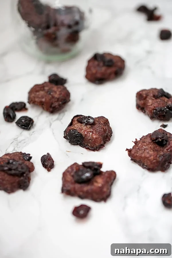 A cluster of homemade Cranberry Beef Jerky Bites on a baking sheet, ready to be enjoyed