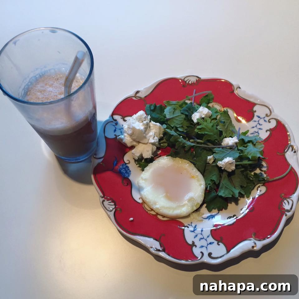 The Weekend Unfolds 3 Healthy breakfast plate with eggs, kale, and cold brew coffee on a wooden table.