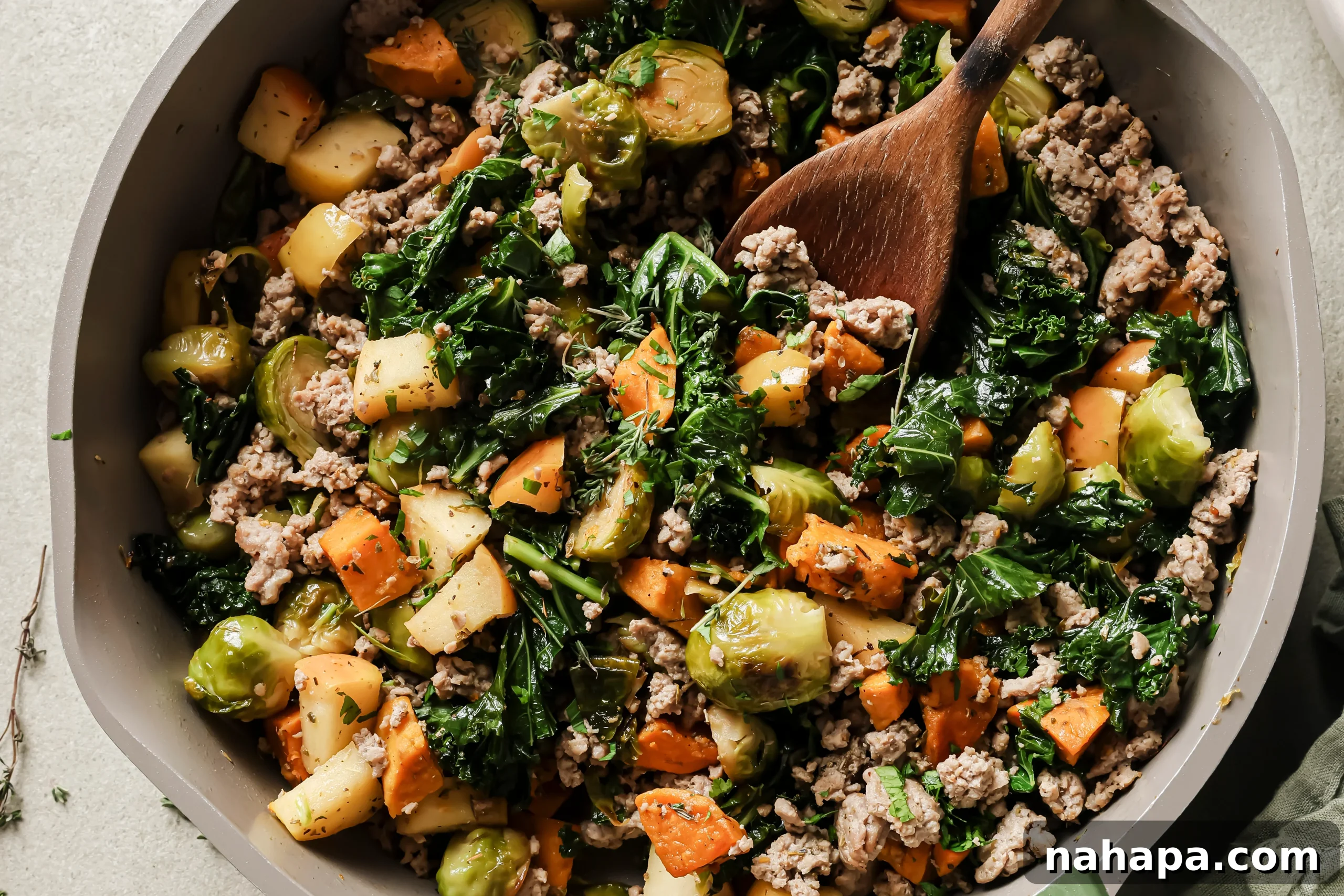 The fully cooked turkey and sweet potato breakfast hash in the pan, ready to be served.